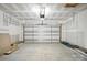 Open garage space with a garage door and overhead lighting. Ready for your vehicles and projects at 149 Prestwick Way # 39, Mooresville, NC 28115