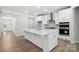 Modern kitchen with a large island, stainless steel appliances, and pristine white cabinets at 149 Prestwick Way # 39, Mooresville, NC 28115