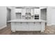 Spacious kitchen island with white cabinetry, stainless steel appliances, and modern finishes at 149 Prestwick Way # 39, Mooresville, NC 28115