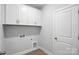Functional laundry room with white cabinetry, modern fixtures, and plenty of storage space at 149 Prestwick Way # 39, Mooresville, NC 28115
