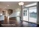 Spacious living room with sliding glass door, hardwood floors, and modern light fixture at 149 Prestwick Way # 39, Mooresville, NC 28115