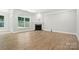 Living room with fireplace, hardwood floors, and large windows with backyard view at 149 Prestwick Way # 39, Mooresville, NC 28115