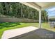 Covered patio area of this home overlooks a backyard with retaining wall and lush green landscaping at 149 Prestwick Way # 39, Mooresville, NC 28115
