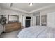 Bright bedroom with tray ceiling, modern dresser, and calming decor creating a serene retreat at 16764 Summers Walk Blvd, Davidson, NC 28036