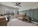 Cozy Bedroom features a crib, rocking chair, and charming leafy wallpaper at 16764 Summers Walk Blvd, Davidson, NC 28036