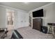 Comfortable bedroom with neutral carpet, spacious closets, and a modern entertainment setup at 16764 Summers Walk Blvd, Davidson, NC 28036