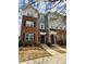 Stylish three-story townhome with brick and siding exterior, complemented by well-maintained landscaping at 16764 Summers Walk Blvd, Davidson, NC 28036