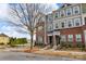 Street view of modern townhomes features brick and siding, with landscaping and street signage at 16764 Summers Walk Blvd, Davidson, NC 28036
