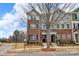 View of well-maintained townhomes with brick facades, complemented by street signs and landscaping at 16764 Summers Walk Blvd, Davidson, NC 28036