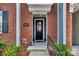 Close-up of a welcoming townhome entrance with brick accents and a stylish black door at 16764 Summers Walk Blvd, Davidson, NC 28036