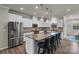 Spacious kitchen with stainless steel appliances and a large granite island with chairs at 16764 Summers Walk Blvd, Davidson, NC 28036