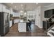 Spacious kitchen boasts white cabinets, stainless steel appliances, and a large island with seating at 16764 Summers Walk Blvd, Davidson, NC 28036