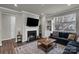 Open-concept living room featuring a fireplace, a TV, a couch and a large window at 16764 Summers Walk Blvd, Davidson, NC 28036