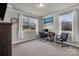 Bright office space featuring large windows, neutral tones, and a functional modern desk setup at 16764 Summers Walk Blvd, Davidson, NC 28036