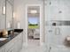 Luxurious primary bathroom features double vanity, granite countertops and a glass enclosed shower at 19035 Newburg Hill Rd, Davidson, NC 28036