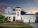 Beautiful two-story home showcasing a charming facade, front porch, and a two-car garage at dusk at 19035 Newburg Hill Rd, Davidson, NC 28036