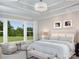 Bright main bedroom with large windows and seating area showcasing a stunning outdoor view at 19035 Newburg Hill Rd, Davidson, NC 28036