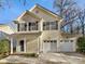 Charming two-story home with cream-colored siding, black shutters, and a two-car garage at 225 Howe St, Belmont, NC 28012