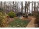 A beautifully landscaped backyard with a screened gazebo, lush greenery, and stone pathway at 2622 Oakhurst Dr # 23, Rock Hill, SC 29730