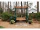 Wooden bench swing with an arbor in a landscaped backyard with pea gravel at 2622 Oakhurst Dr # 23, Rock Hill, SC 29730