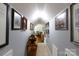 Hallway with light gray walls and multiple framed pictures at 2622 Oakhurst Dr # 23, Rock Hill, SC 29730