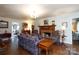Cozy living room featuring a brick fireplace, hardwood floors, and traditional furnishings at 2622 Oakhurst Dr # 23, Rock Hill, SC 29730