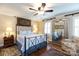 Bedroom featuring a beautiful four-poster bed, hardwood floors, ceiling fan and large window at 2622 Oakhurst Dr # 23, Rock Hill, SC 29730