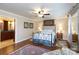 Bedroom featuring a beautiful four-poster bed, hardwood floors, ceiling fan and ensuite bathroom at 2622 Oakhurst Dr # 23, Rock Hill, SC 29730