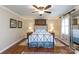 Bedroom featuring a beautiful four-poster bed, hardwood floors, ceiling fan and large window at 2622 Oakhurst Dr # 23, Rock Hill, SC 29730