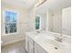 Bright bathroom with double sink vanity, tiled floors, and natural light from a large window at 2683 Beulah Church Rd, Matthews, NC 28104