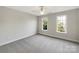 Bright bedroom features neutral carpeting, two bright windows, and a ceiling fan at 2683 Beulah Church Rd, Matthews, NC 28104