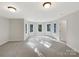 Spacious bonus room featuring neutral carpeting and natural light from multiple windows at 2683 Beulah Church Rd, Matthews, NC 28104