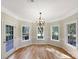 Cozy breakfast nook with wood floors and ample natural light from multiple windows and a door at 2683 Beulah Church Rd, Matthews, NC 28104