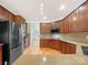 Spacious kitchen featuring dark wood cabinetry, granite counters, and stainless steel appliances at 2683 Beulah Church Rd, Matthews, NC 28104