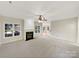 Spacious living room featuring a fireplace, large windows for natural light, and neutral carpeting at 2683 Beulah Church Rd, Matthews, NC 28104