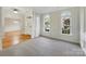 Bright living room featuring paneled walls, arch top windows, and an entryway with hardwood floors at 2683 Beulah Church Rd, Matthews, NC 28104