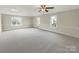 Large, bright main bedroom with neutral carpet, multiple windows, and plenty of open space at 2683 Beulah Church Rd, Matthews, NC 28104