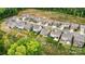 An aerial view shows properties with lush lawns, fences, outdoor patios, and proximity to a tree-lined neighborhood at 3193 Burnello Ct, Iron Station, NC 28080