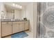 Bathroom featuring a granite countertop, a large mirror with modern lighting, and stylish floral shower curtain at 3193 Burnello Ct, Iron Station, NC 28080