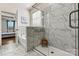 This bathroom features a glass shower with white marble tile and a bench inside at 3193 Burnello Ct, Iron Station, NC 28080