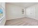 Neutral-toned bedroom with ample natural light, featuring wide-slat blinds and a spacious double-door closet at 3193 Burnello Ct, Iron Station, NC 28080