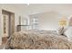 Bright bedroom featuring a light dresser with mirror, a large paisley bedspread, and neutral-toned walls at 3193 Burnello Ct, Iron Station, NC 28080