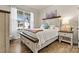 Cozy bedroom with a decorative headboard, side table, and lots of sunlight at 3193 Burnello Ct, Iron Station, NC 28080