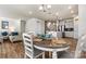 Open-concept dining area adjacent to the kitchen with seating for six and wood floors at 3193 Burnello Ct, Iron Station, NC 28080