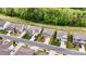 An exterior view shows multiple two-story homes with manicured lawns, driveways, and lush surrounding trees at 3193 Burnello Ct, Iron Station, NC 28080