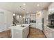 A modern kitchen with an island, stainless steel appliances and sleek countertops at 3193 Burnello Ct, Iron Station, NC 28080