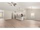 Open-concept living area with wood-look floors, kitchen with an island, modern lighting, and stainless steel appliances at 3524 Narrow Ln, Charlotte, NC 28215