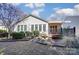 Picturesque backyard showcasing a deck with awning, complemented by a water feature and lush landscaping at 41108 Calla Lily St, Fort Mill, SC 29707