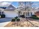 Charming home featuring a well-maintained yard and blooming tree in a peaceful setting at 41108 Calla Lily St, Fort Mill, SC 29707