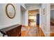 Inviting foyer with hardwood floors, elegant wainscoting, and views into the living area at 41108 Calla Lily St, Fort Mill, SC 29707